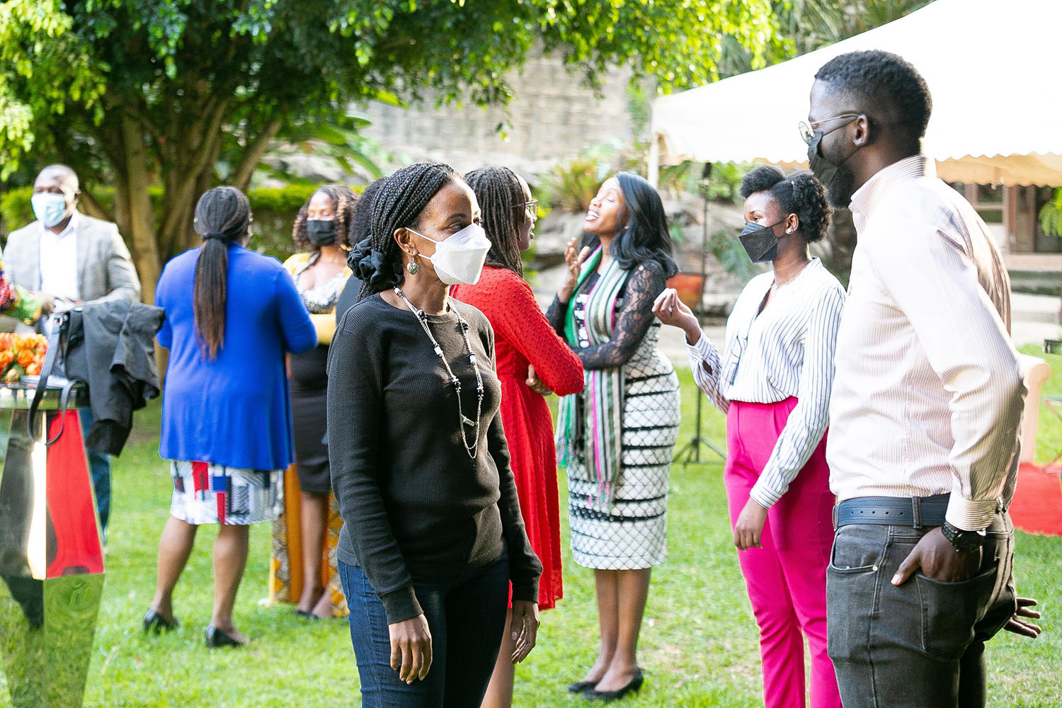We bring leaders of change together and spark conversations. Participants stand in pairs on the meadow of the event location hosting the opening of the Ashoka Visionary Program in East Africa.